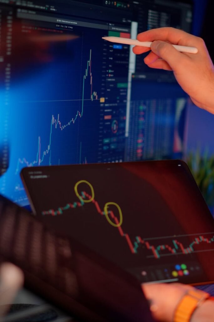 A person analyzes cryptocurrency market trends on multiple screens with graphs.